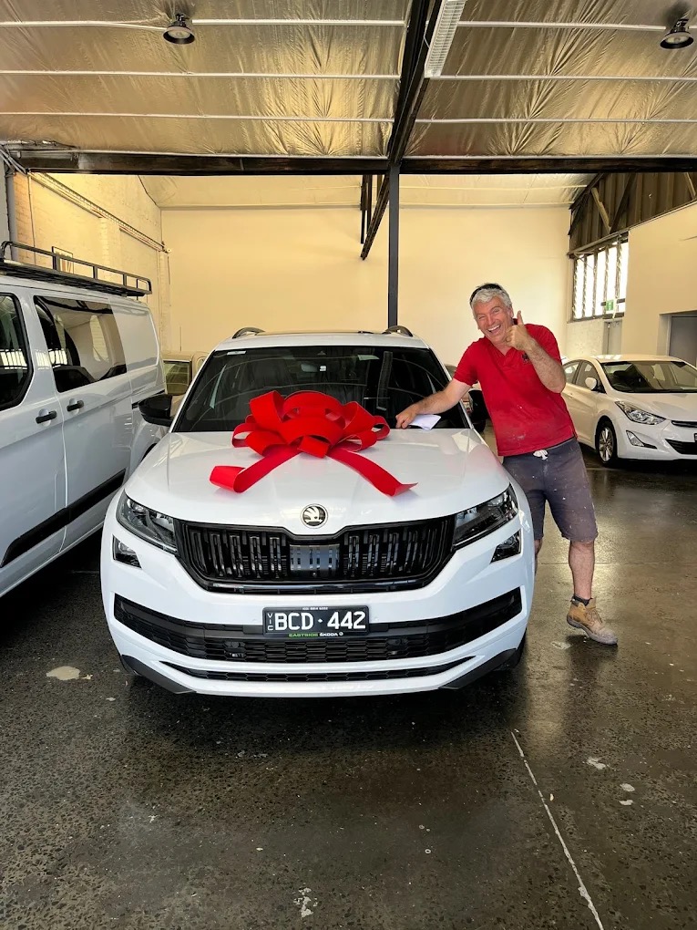 A happy customer picking up his new car at Pick A Ride, Blackburn Victoria
