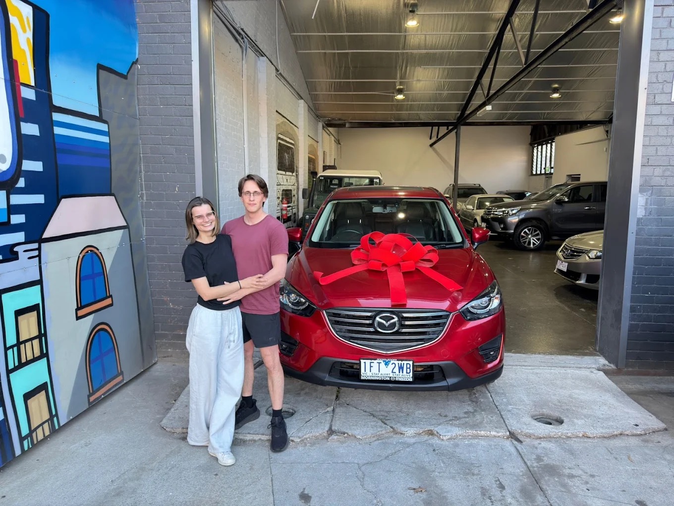 A couple picking up their new Mazda at Pick A Ride, Blackburn VIC