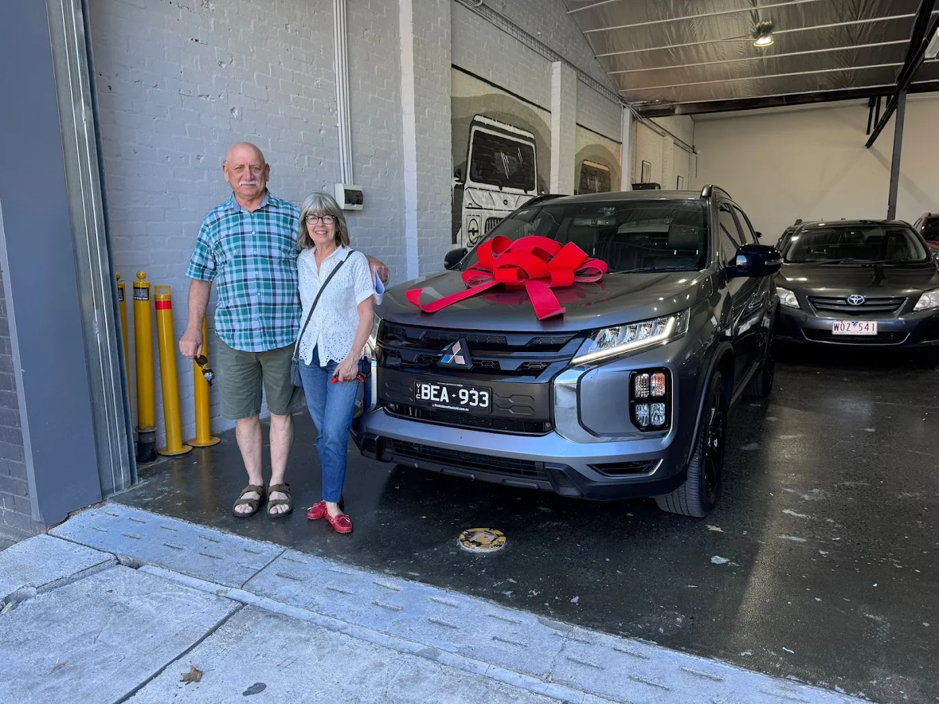 A couple collecting their Mitsubishi from Pick A Ride in Blackburn